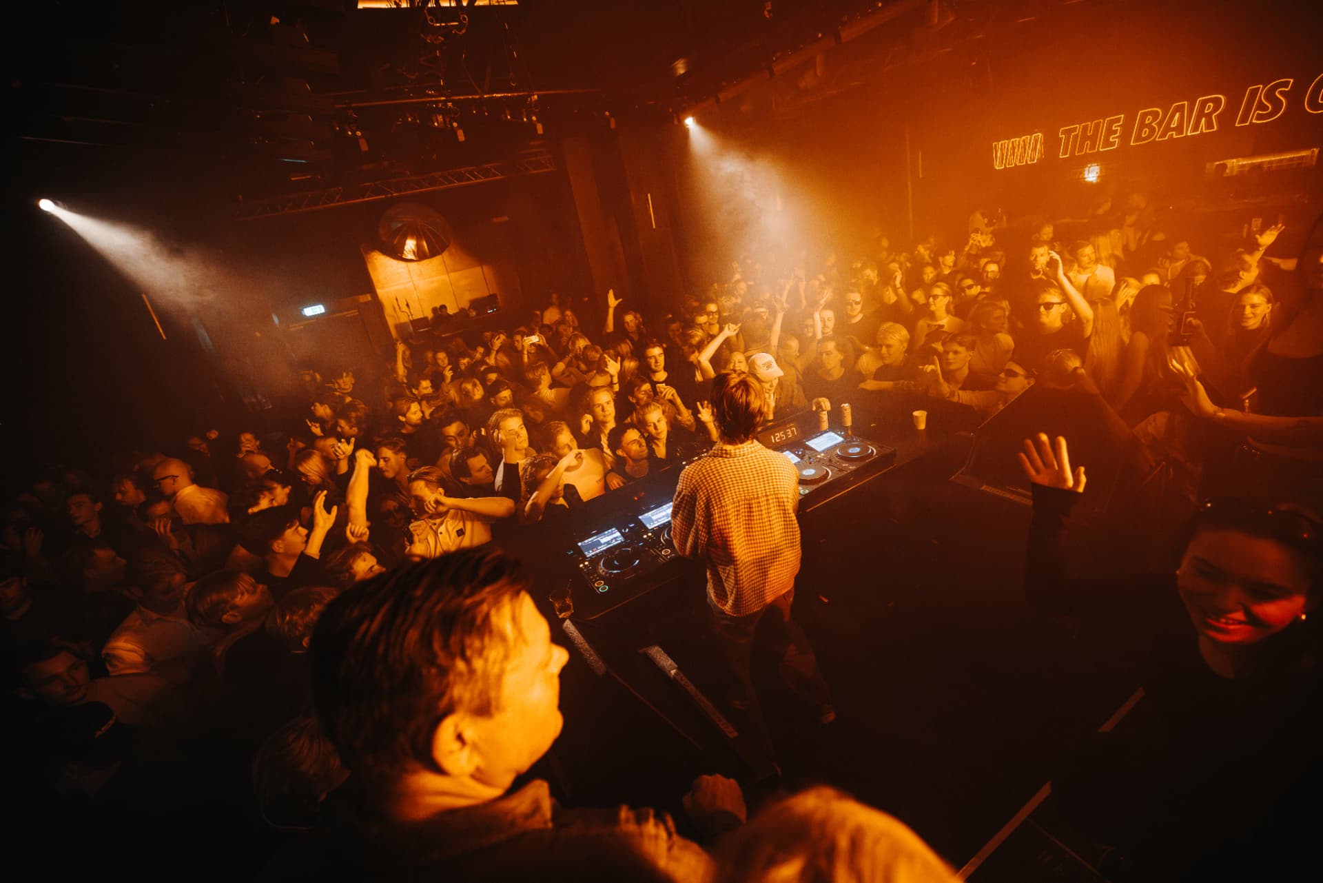 Packed crowd seen from behind the decks